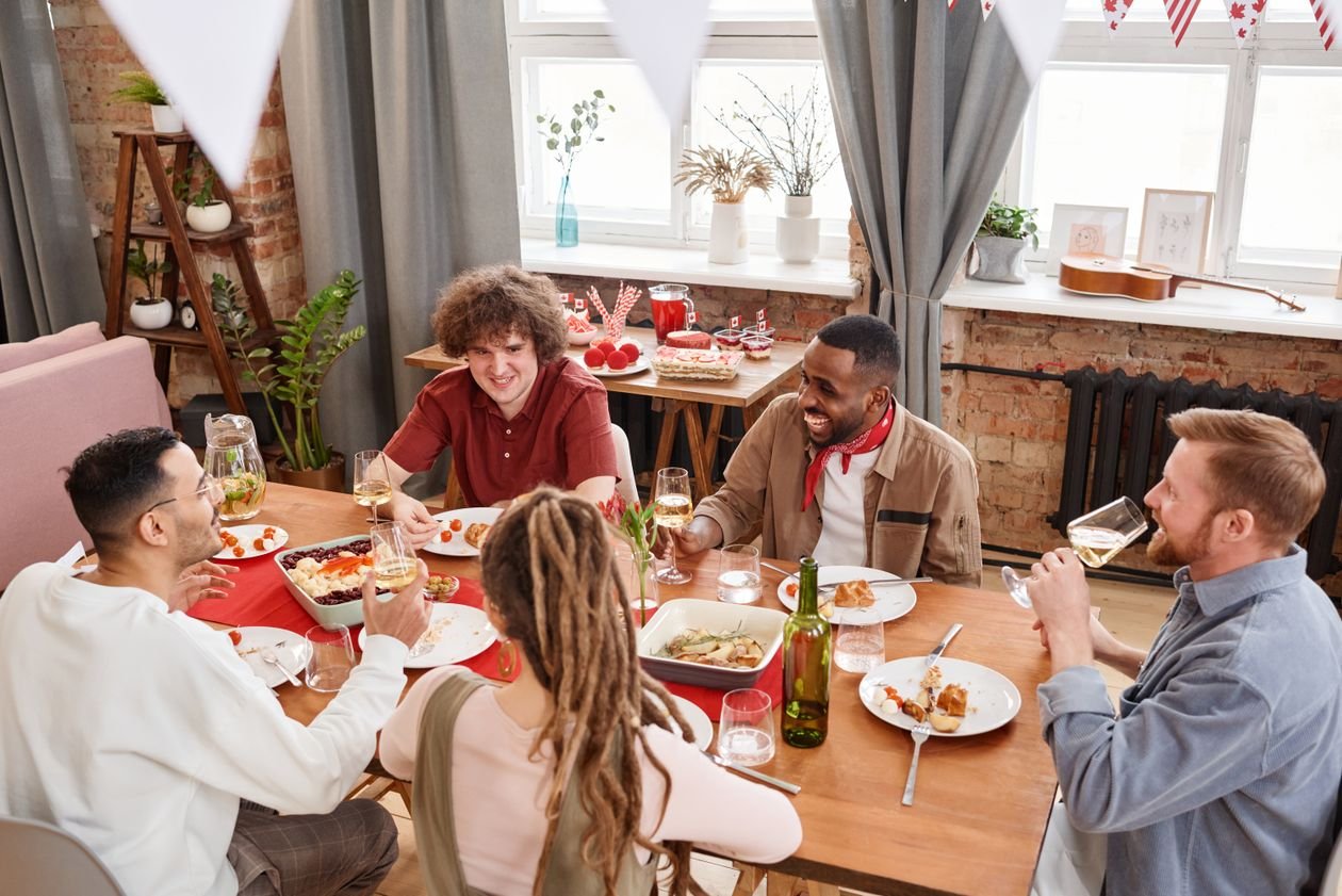 Community dinner with people sharing a meal in warm evening light