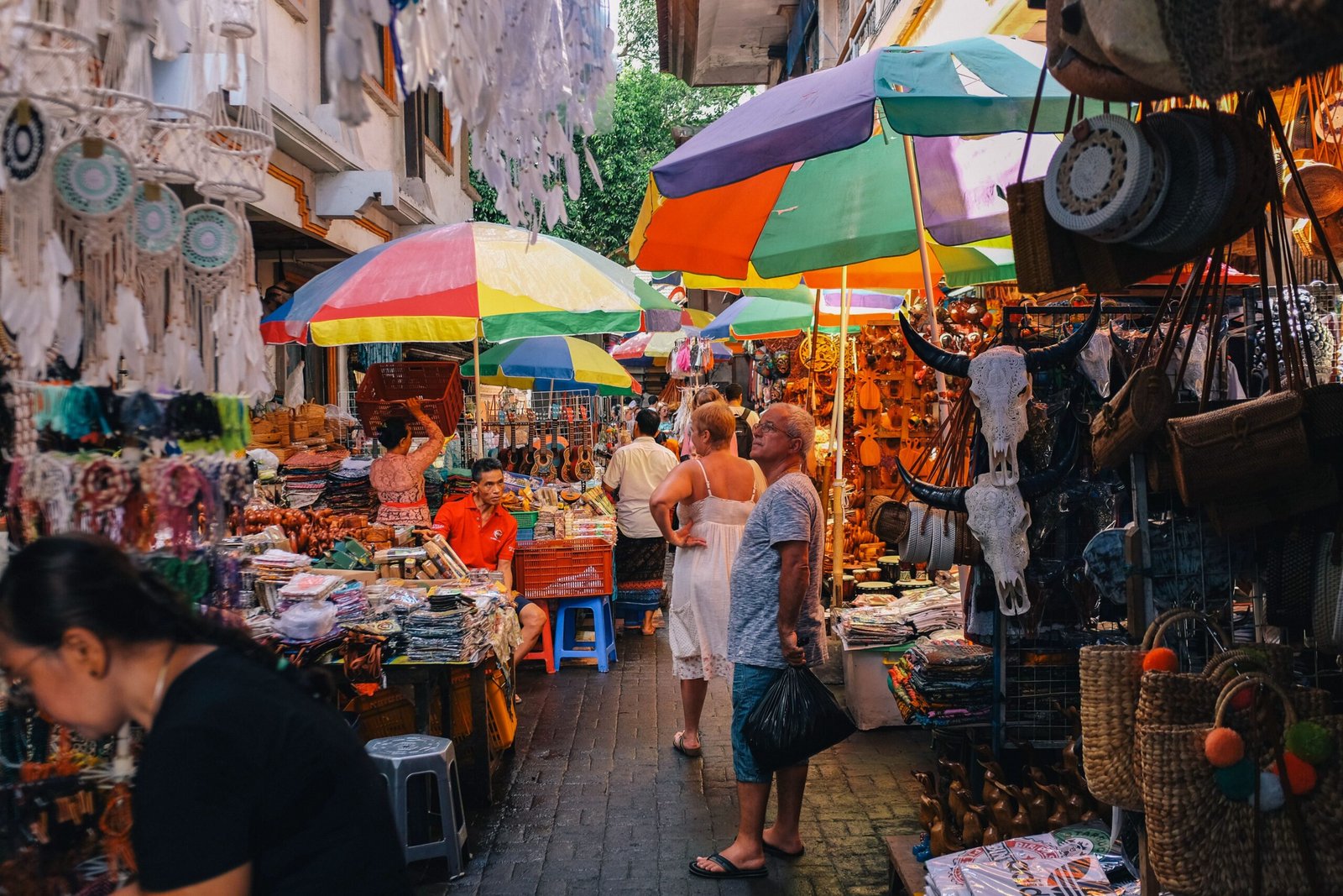 Bustling outdoor market with vibrant stalls and diverse shoppers
