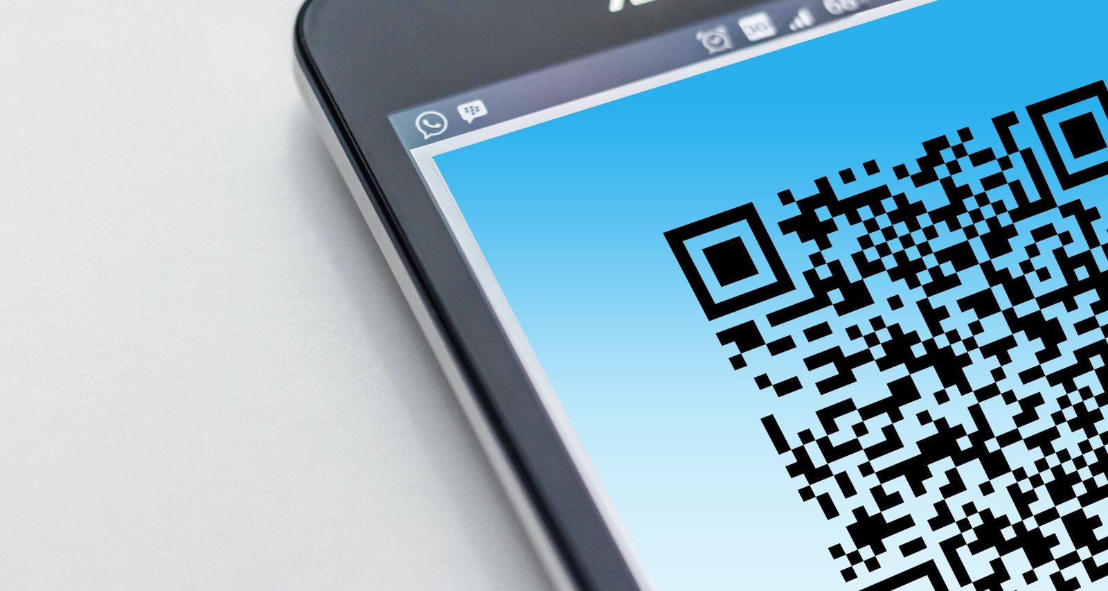 High-resolution close-up of a smartphone displaying a QR code on its screen