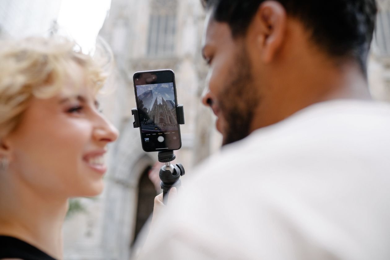 Content creator filming a vertical video at a venue with a smartphone