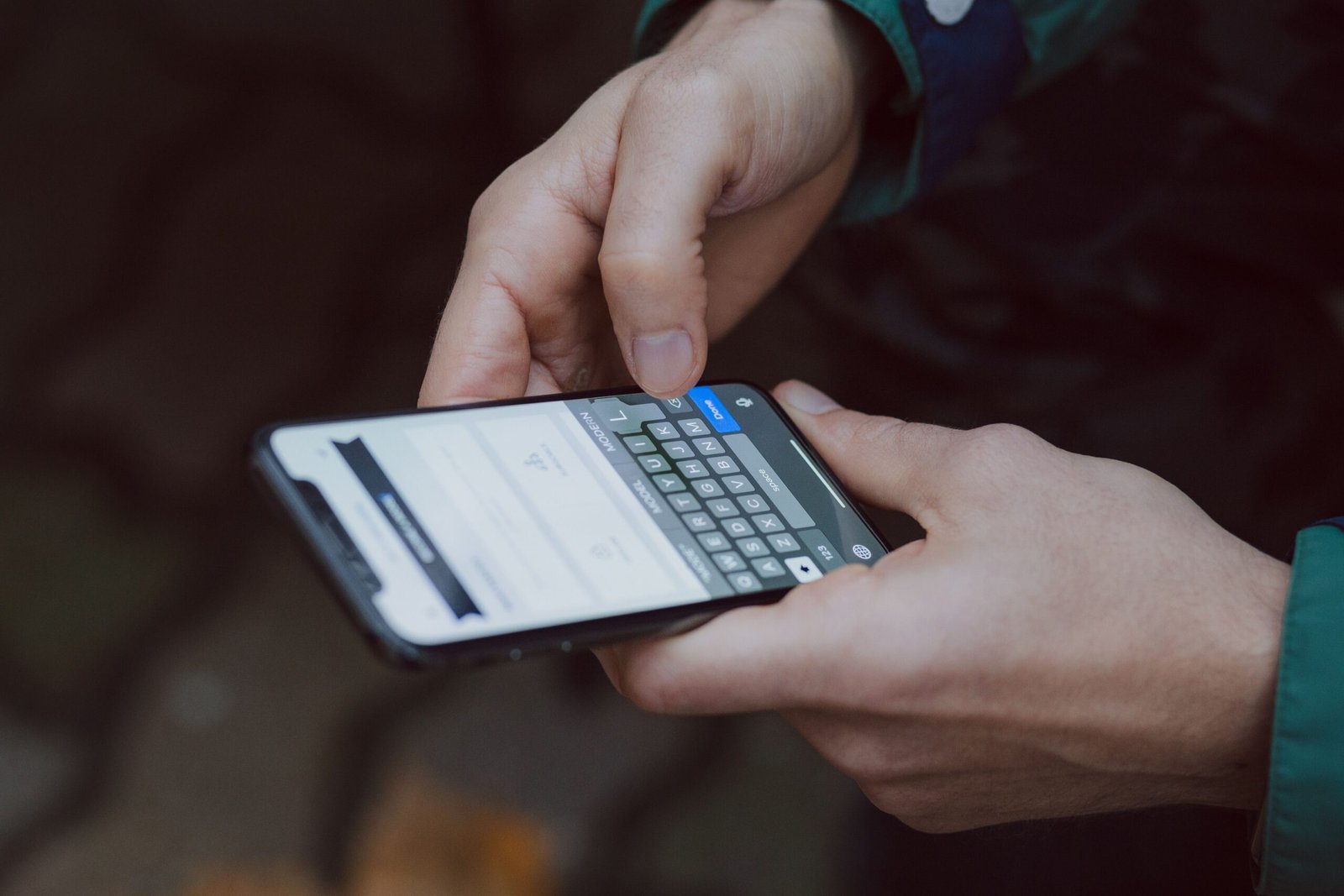 Outdoor setting of a close-up person filling an online form on a smartphone