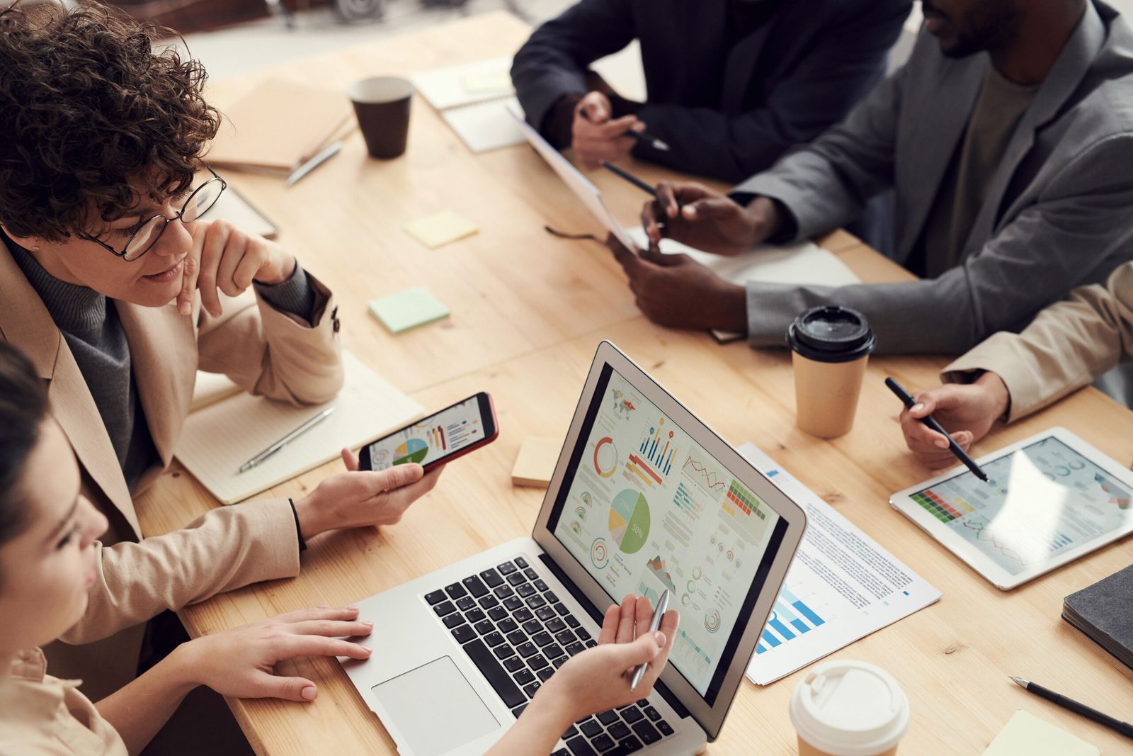 A multicultural team discussing analytics and strategy in a modern office setting