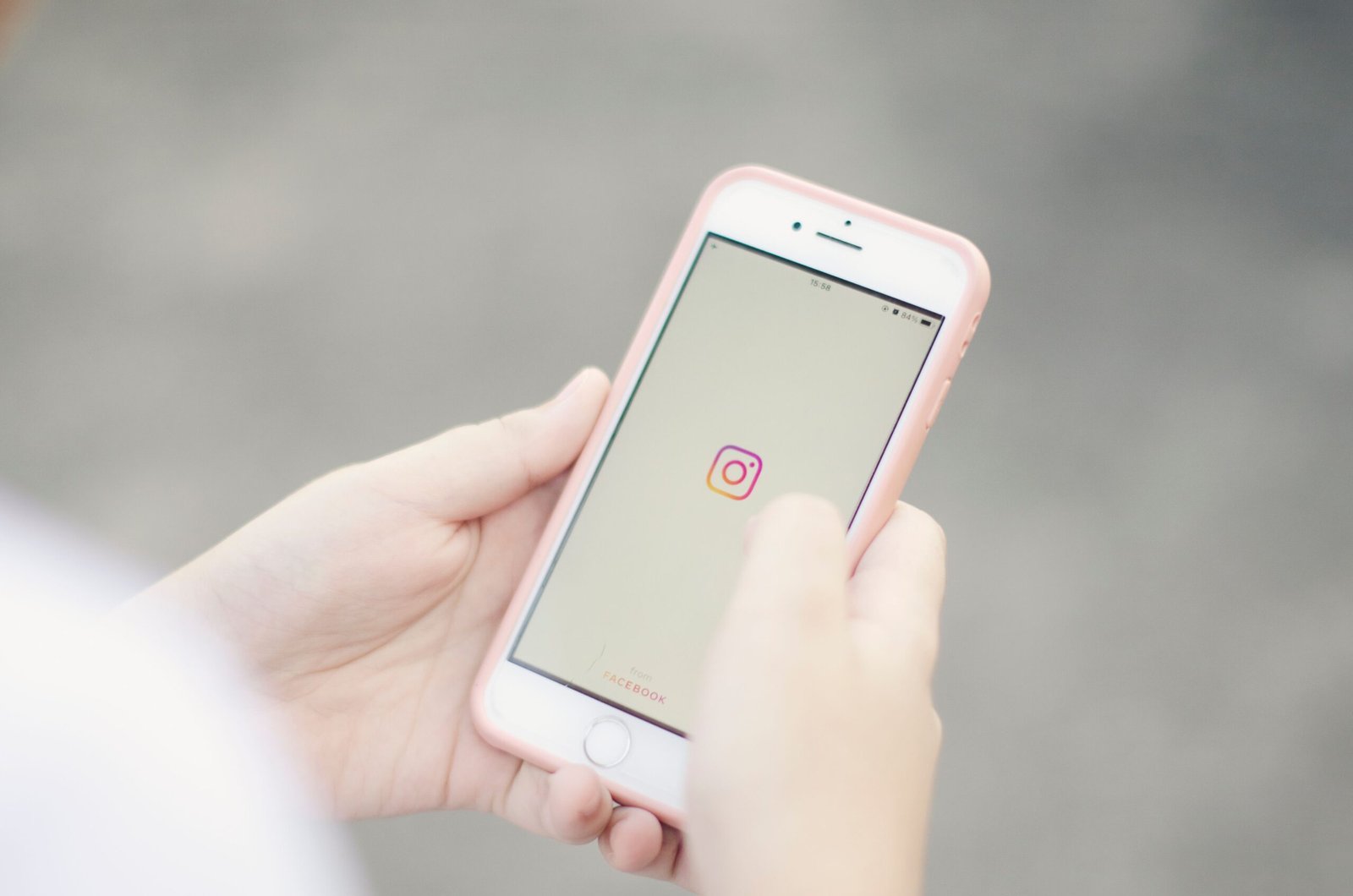 Hands holding a smartphone opening the Instagram app, used for restaurant ads