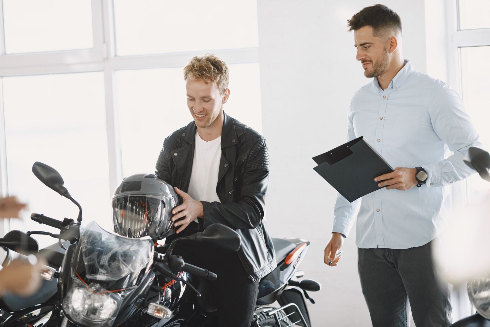 Two men at scooter rentals discussing about a rental purchase