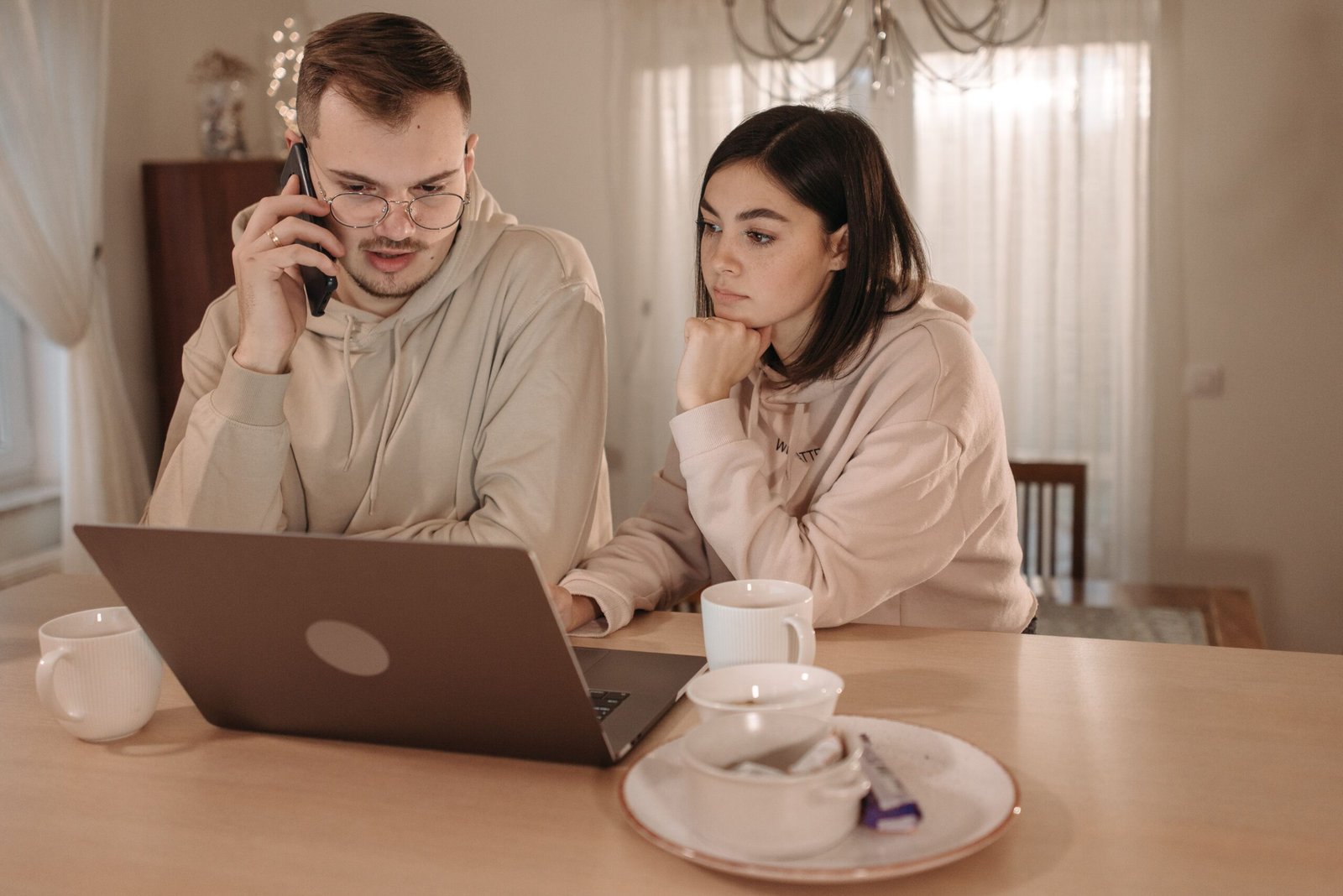 Couple looking at a laptop together while planning their wedding